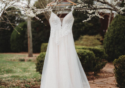 Gallery Image of Wedding Dress Hanging from Tree